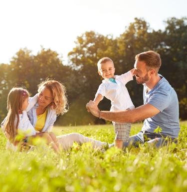 family chilling in a field